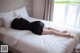 A woman laying on a bed in a hotel room.