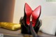 A pair of red high heels sitting on top of a table.